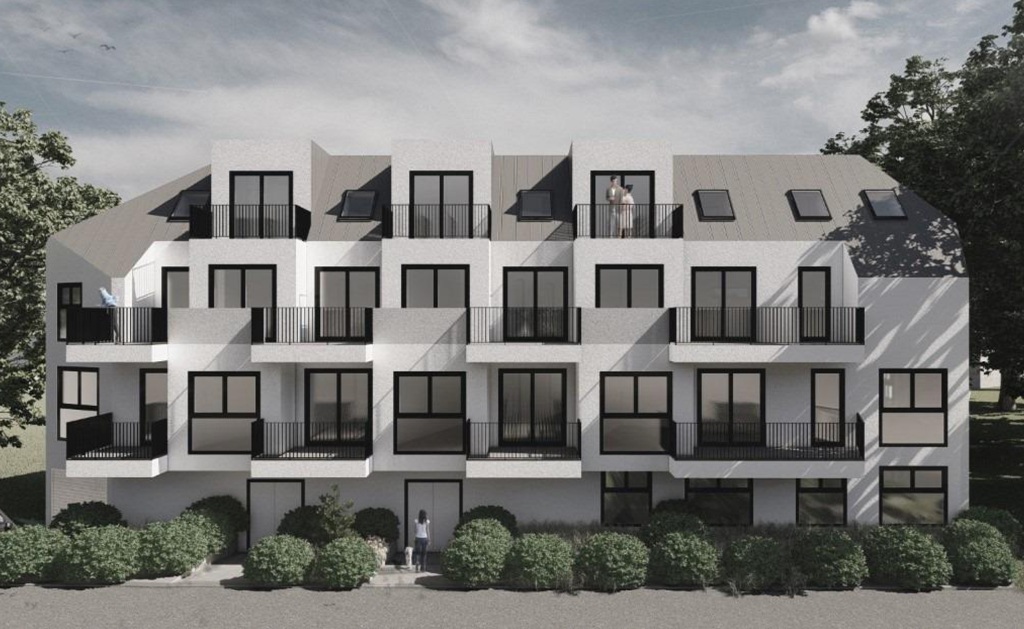 moderne Wohnhausanlage, 11. Bezirk Wiens, helle Fassade, dunkle Fenster und Balkone
